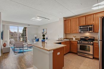 A kitchen with a refrigerator, oven, and microwave.